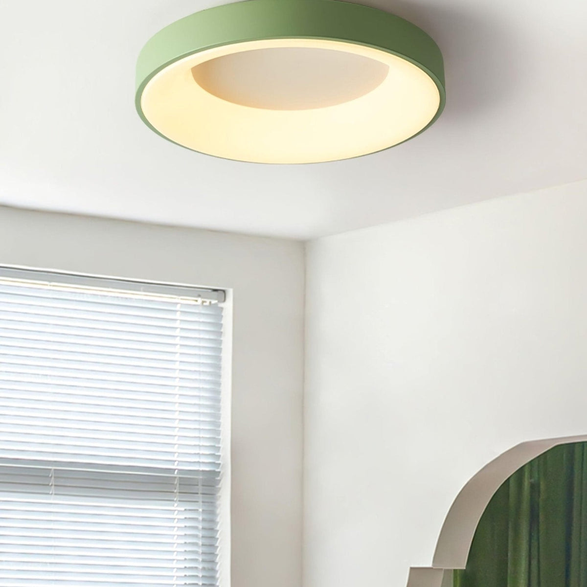 Green recessed-ring LED flush ceiling light mounted on a ceiling