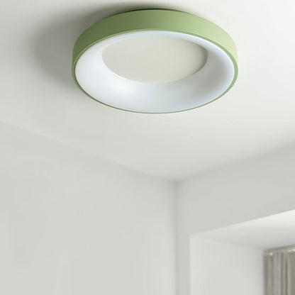 Green recessed-ring LED flush ceiling light mounted on a ceiling