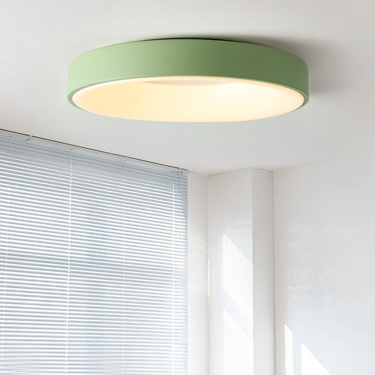 Green recessed-ring LED flush ceiling light mounted on a ceiling