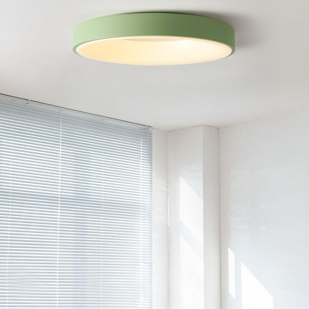 Green recessed-ring LED flush ceiling light mounted on a ceiling