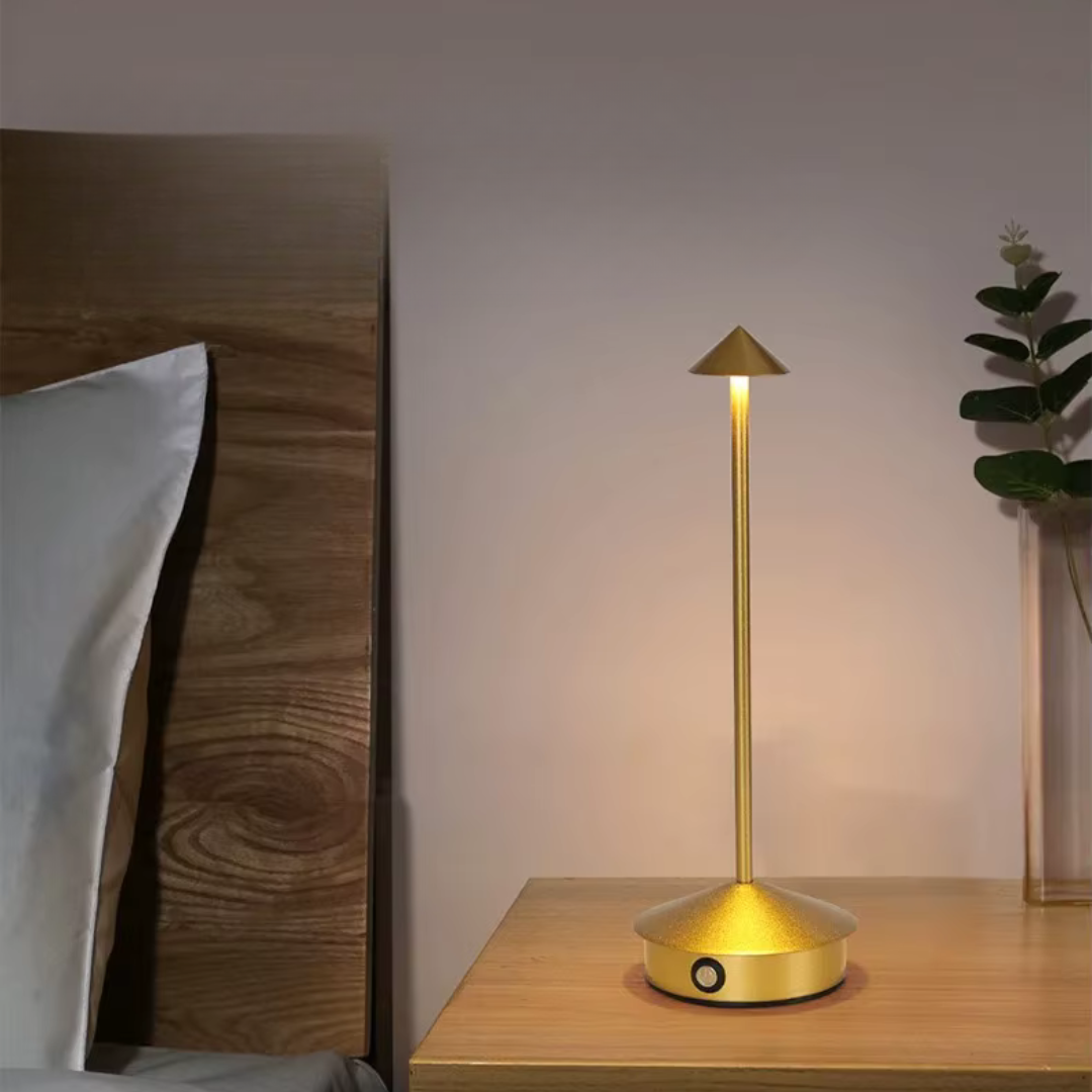 Gold aluminium cone table lamp with warm LED glow