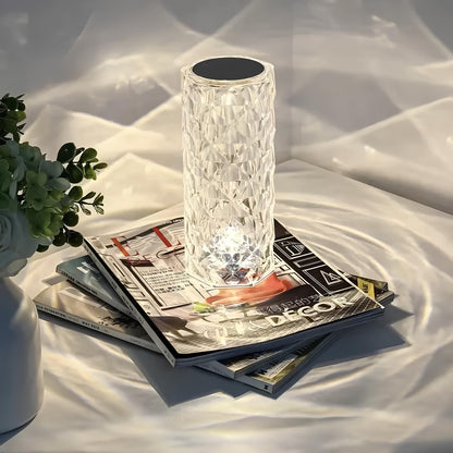 Faceted cylinder lamp on magazines with patterned light