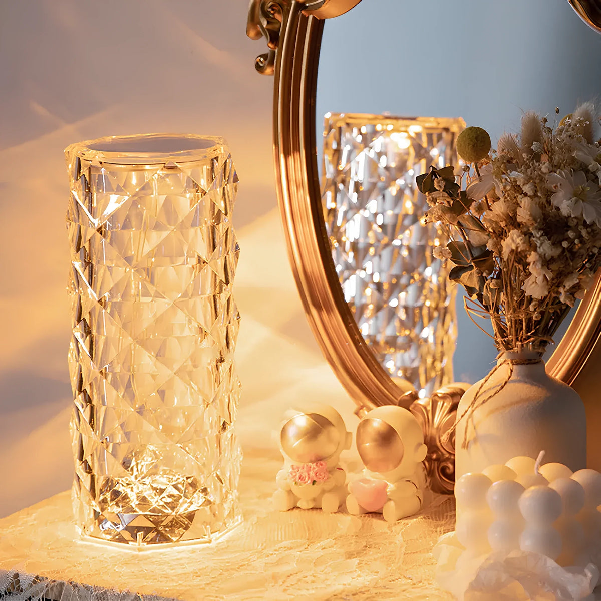 Illuminated crystal-effect cylinder lamp beside a mirror