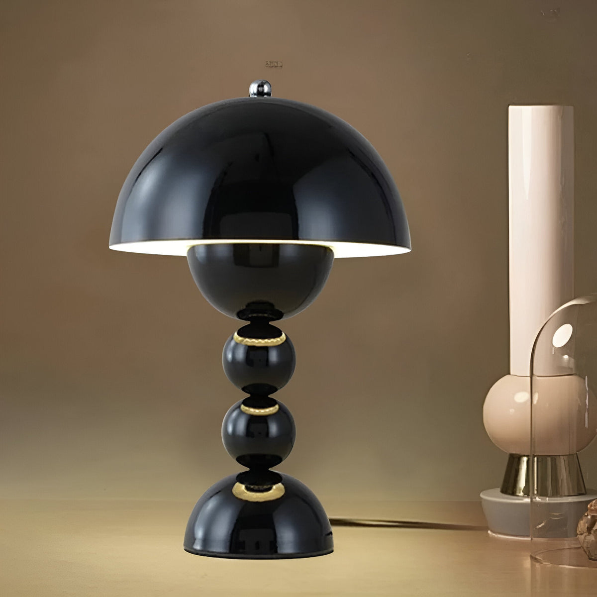 Black dome table lamp with sculptural stacked sphere base