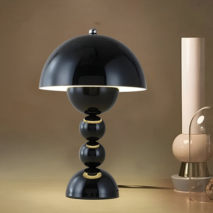 Black dome table lamp with sculptural stacked sphere base