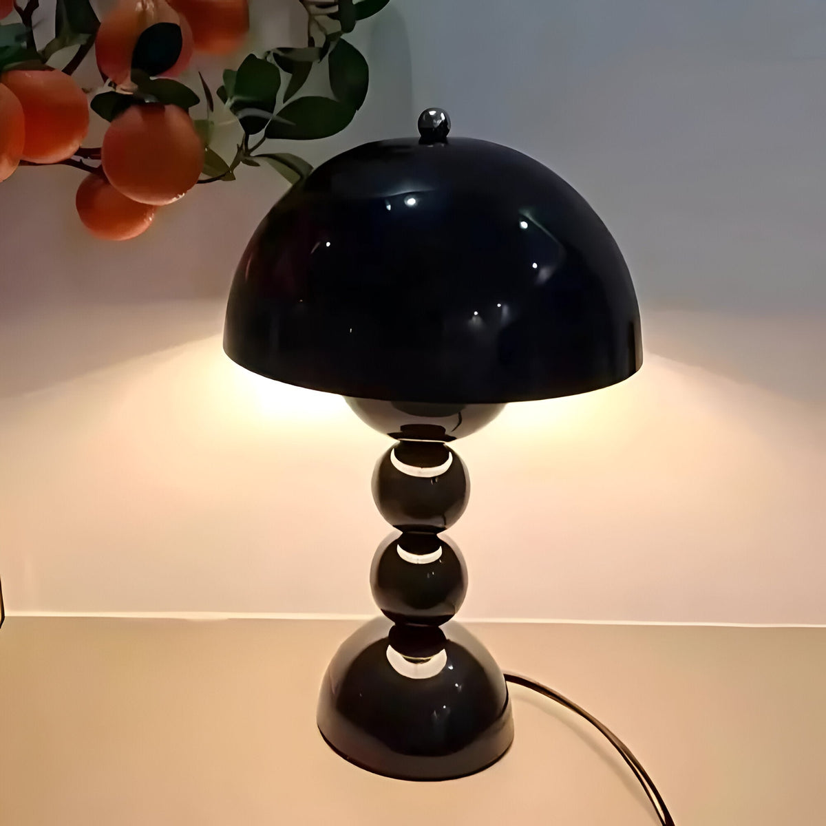 Black dome table lamp with sculptural stacked sphere base