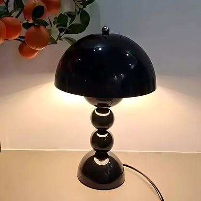 Black dome table lamp with sculptural stacked sphere base