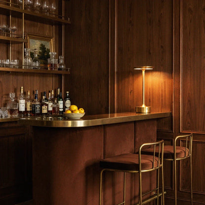 Gold rechargeable table lamp on a bar counter