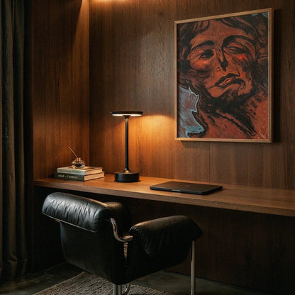 Black rechargeable table lamp on a desk