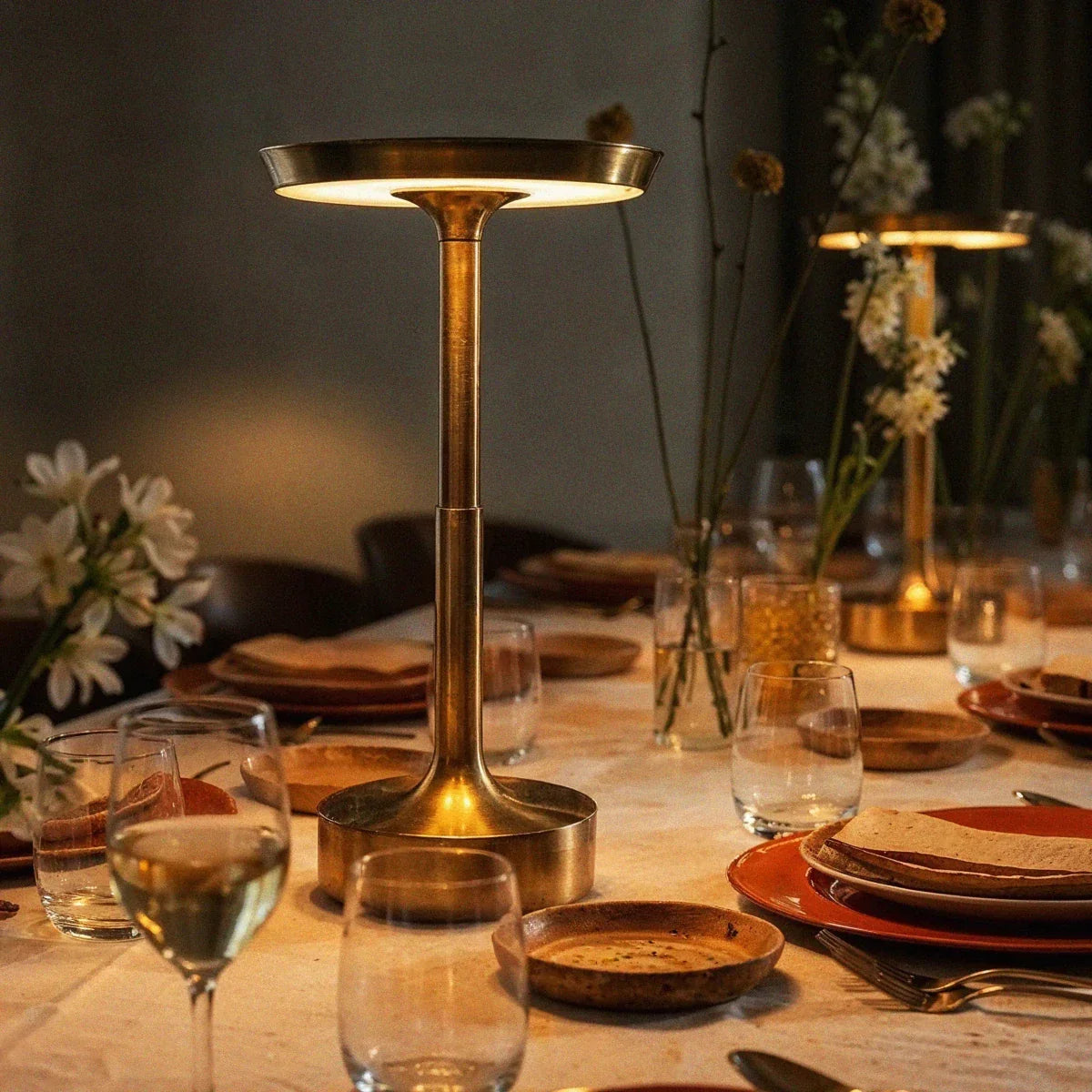 Gold dimmable LED table lamp on a dining table