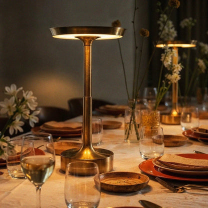 Gold dimmable LED table lamp on a dining table