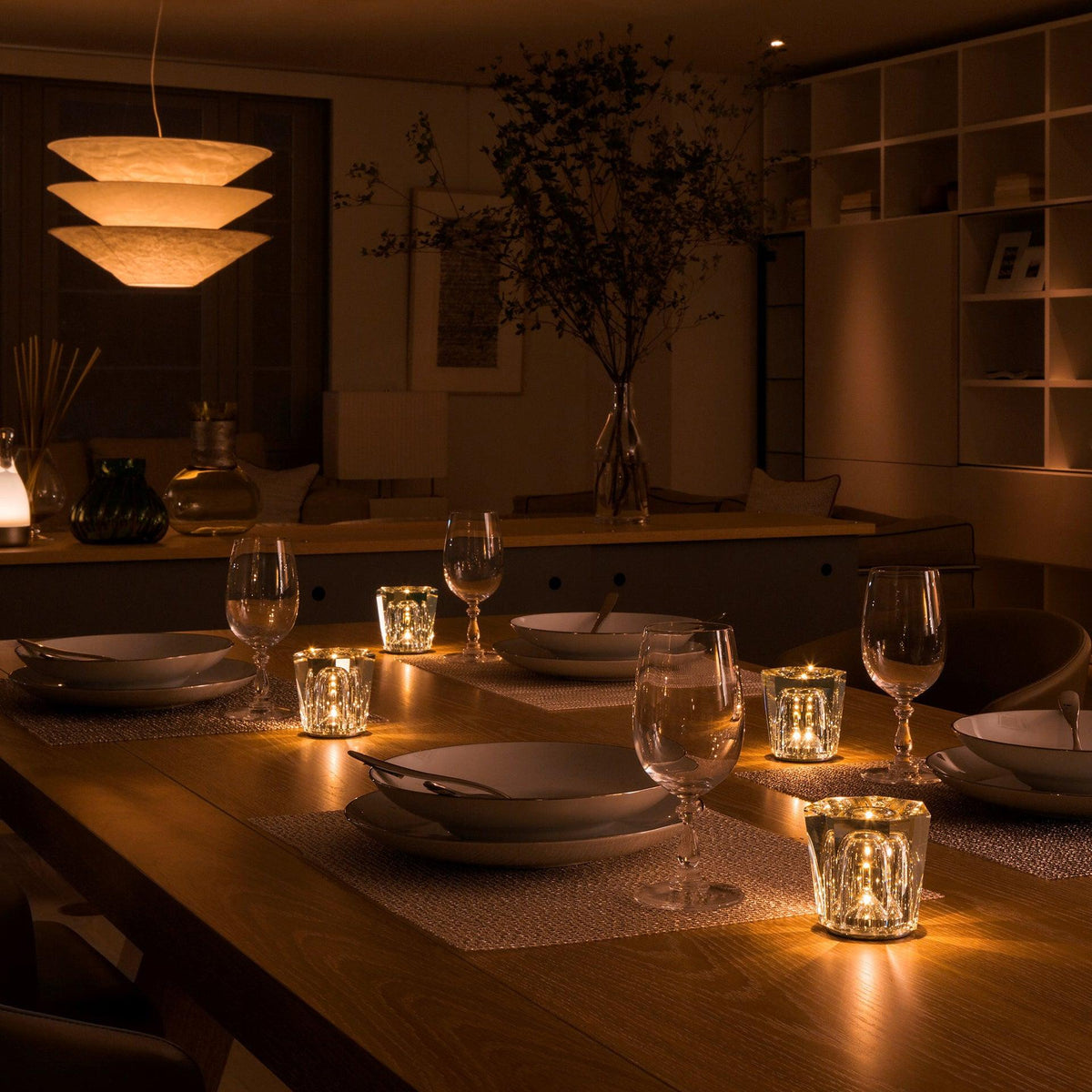 Mini crystal glass lamps casting light patterns on a dining table
