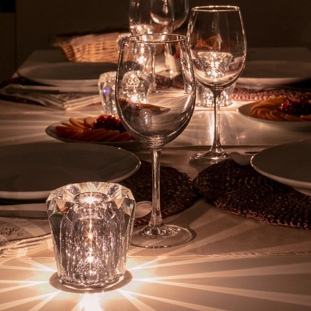 Mini crystal glass lamps casting light patterns on a dining table