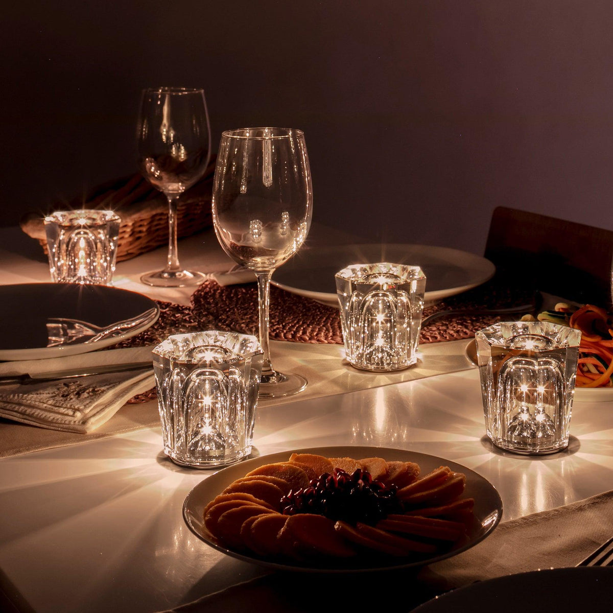 Mini crystal glass lamps casting light patterns on a dining table