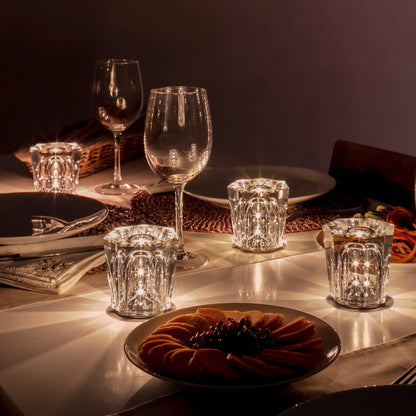 Mini crystal glass lamps casting light patterns on a dining table