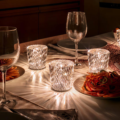 Mini crystal glass lamps casting light patterns on a dining table