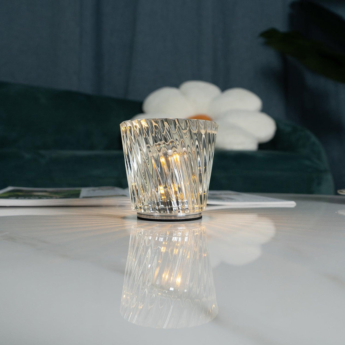 Close-up of spiral-faceted crystal glass table lamp and central LED