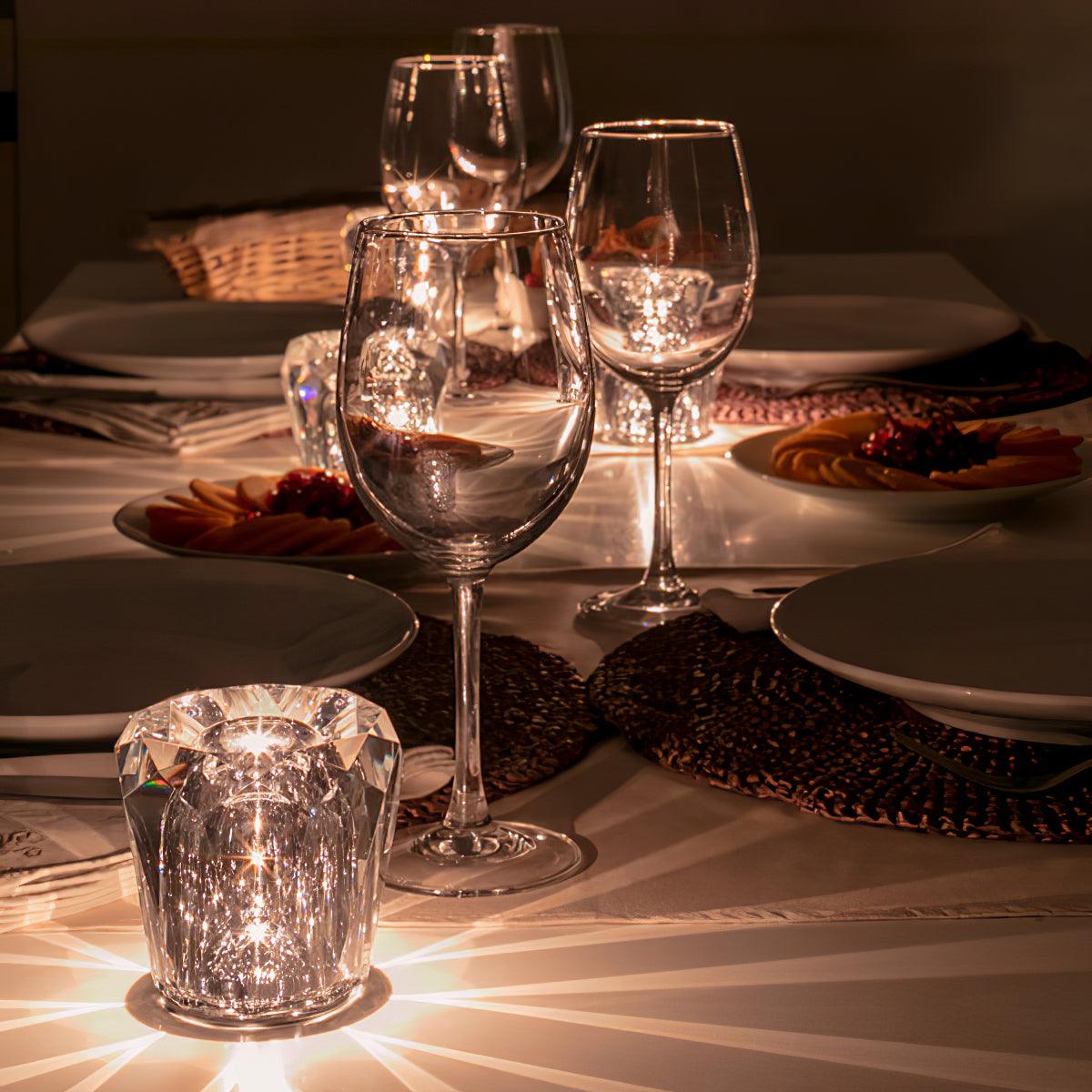 Mini crystal glass lamps casting light patterns on a dining table