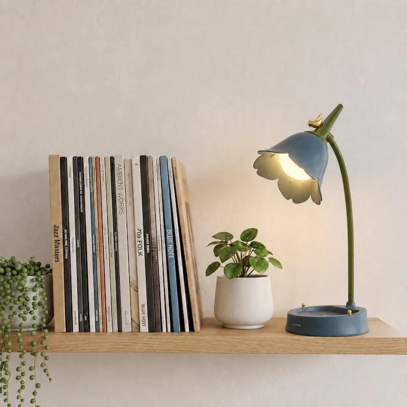 Blue petal lamp beside books