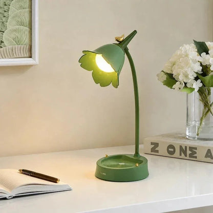 Green flower lamp on a white desk