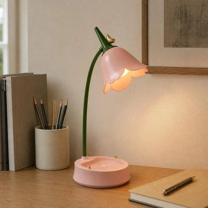 Pink flower lamp beside pencils