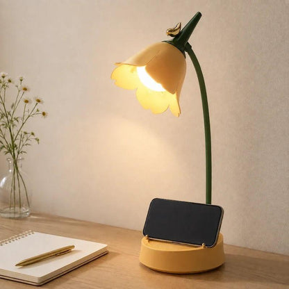 Yellow flower lamp base holding a phone