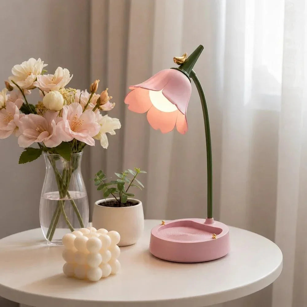 Pink petal shade desk lamp beside flowers