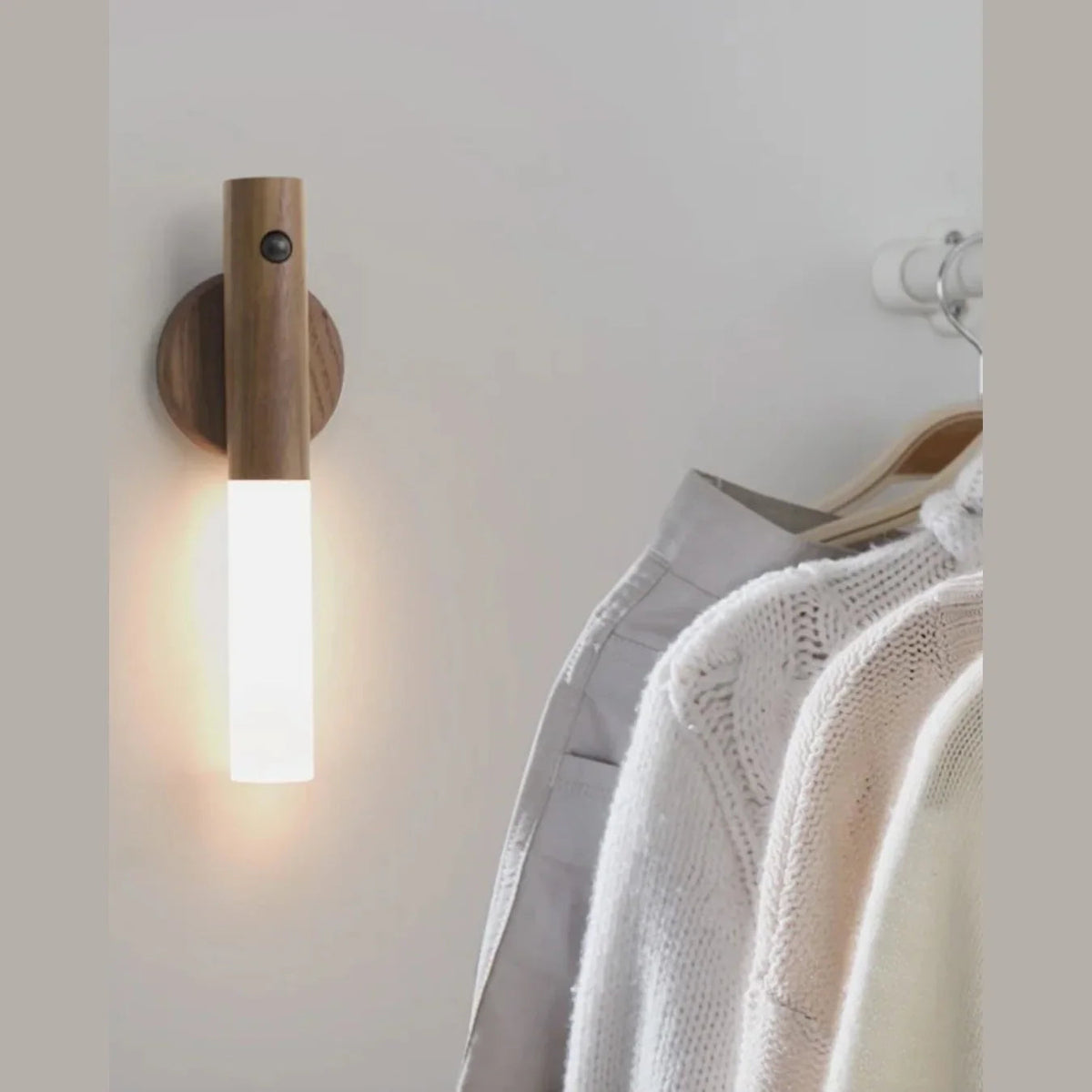 Magnetic motion sensor light beside hanging clothes