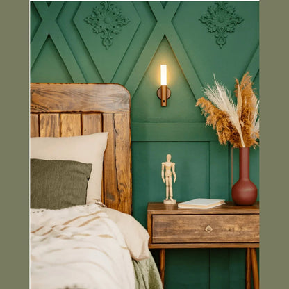 Wood-look magnetic wall light beside a bed
