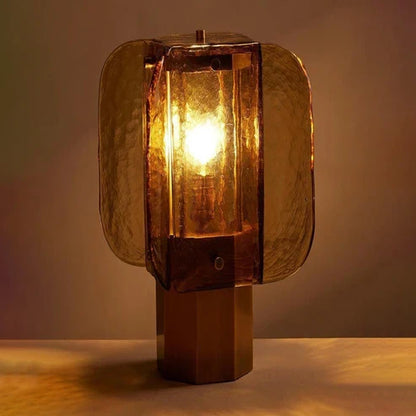 Amber glass lamp glowing on a wooden table
