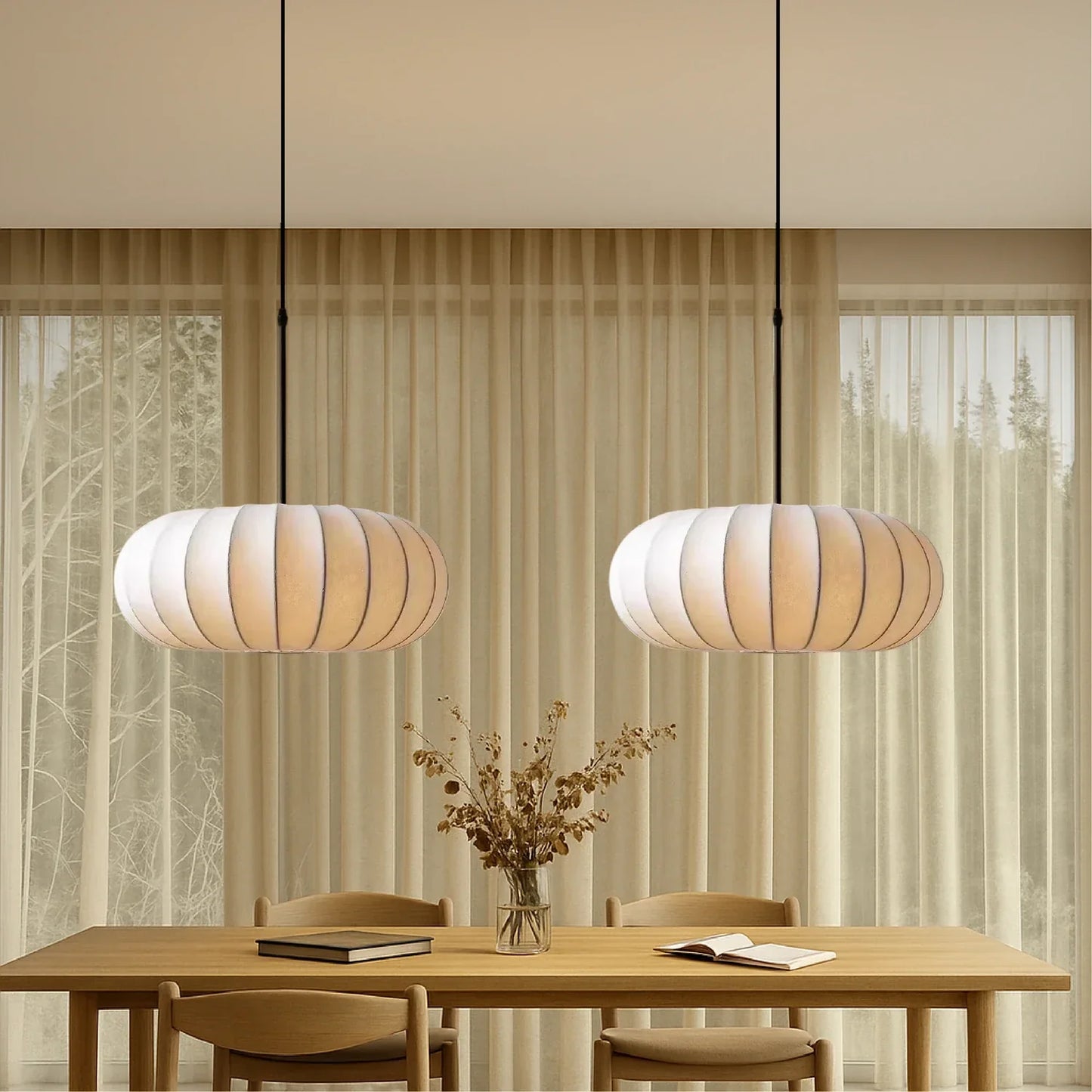 Two retro silk pumpkin pendant lights hanging above a wooden dining table with chairs in a contemporary dining room with neutral curtains.