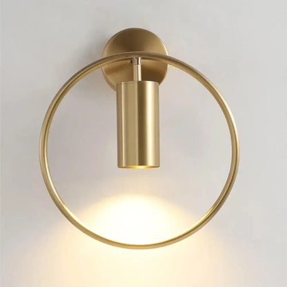 Gold ring wall light with cylindrical spotlight