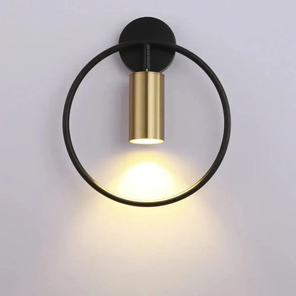 Black ring wall light with gold spotlight