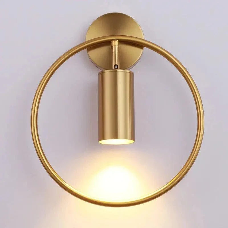Gold ring wall sconce casting downward light