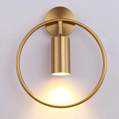 Gold ring wall sconce casting downward light