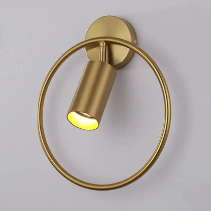 Gold ring wall light with tilted spotlight