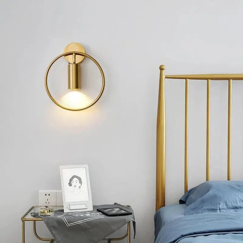 Gold ring spotlight above a bedside table