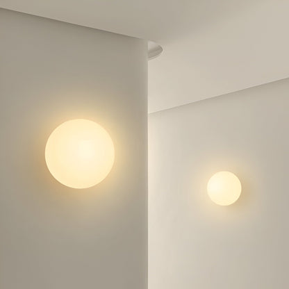 Glass wall sconce in minimalist round design