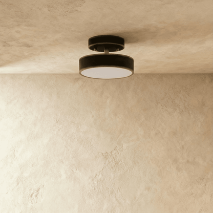 Black round iron semi-flush ceiling light switched off