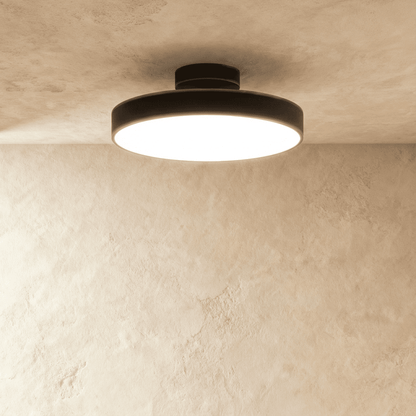 Large black round iron semi-flush light illuminated