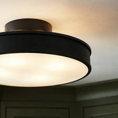 Black round iron ceiling light illuminated diffuser detail