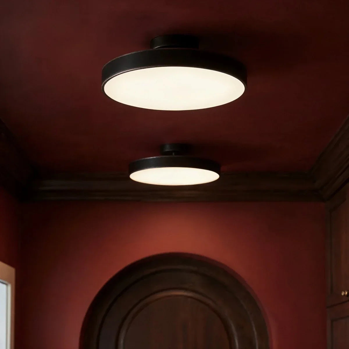 Black round iron ceiling lights in a hallway