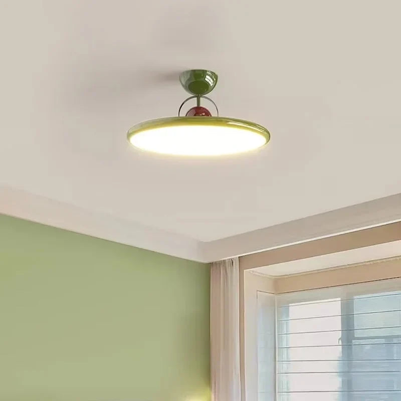 Green round LED semi-flush ceiling light with a disc shade
