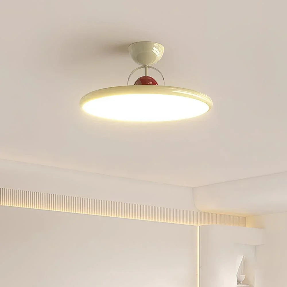Beige LED ceiling light illuminating a bedroom