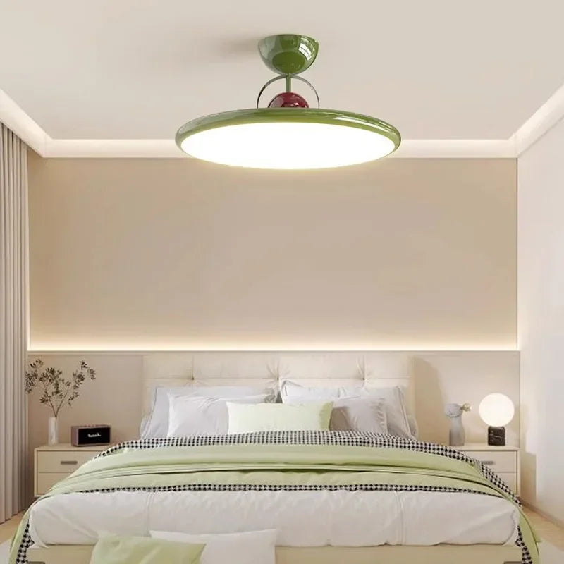 Green LED ceiling light with a white diffuser in a bedroom