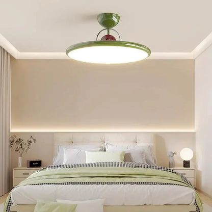 Green LED ceiling light with a white diffuser in a bedroom