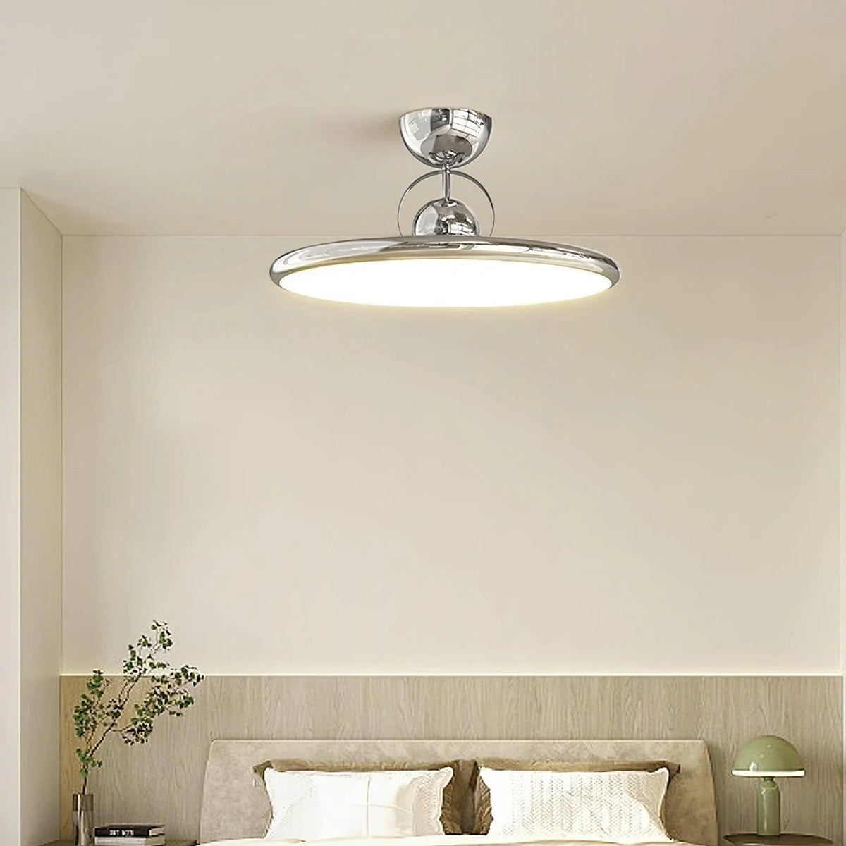 Chrome round LED ceiling light above a bedroom