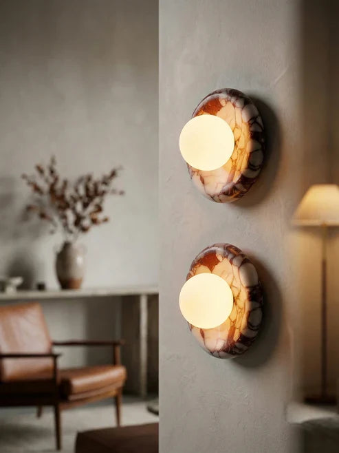 Illuminated marble globe lights on an accent wall