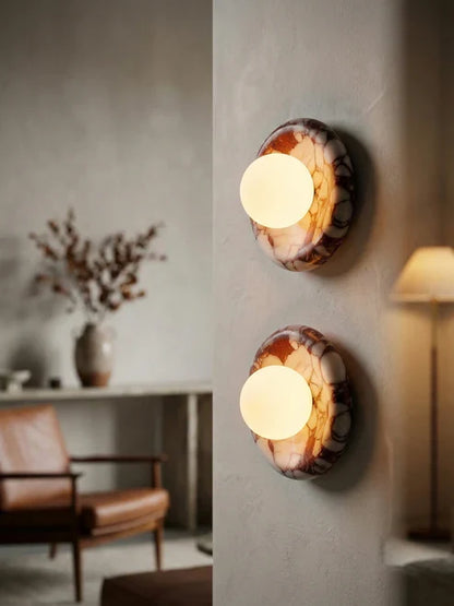 Illuminated marble globe lights on an accent wall