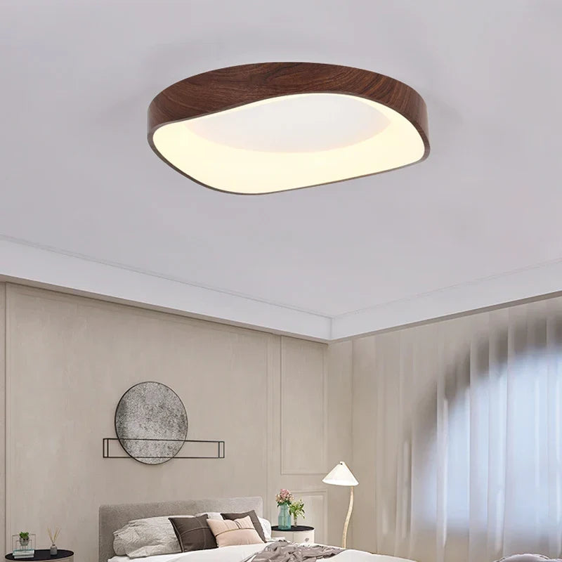 Dark wood-effect LED flush mount ceiling light in a bedroom